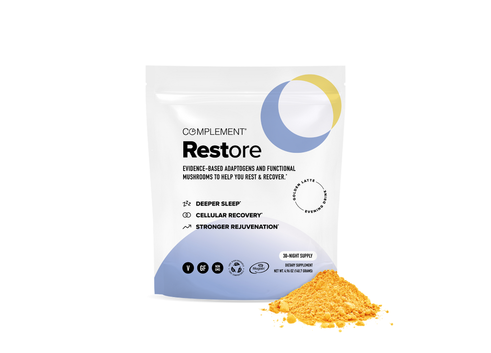 A white pouch labeled Complement Restore beside a small pile of yellow powder. The packaging highlights benefits such as deeper sleep, cellular recovery, and stronger rejuvenation, and features minimalist icons and a circular design.