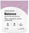 A white and purple pouch labeled Complement Balance dietary supplement for women, highlighting support for energy, cognitive function, immunity, and reproductive health. The package lists key nutrients and serving details.