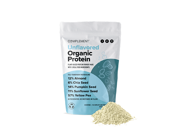 A bag of Complement Unflavored Organic Protein powder is shown. The packaging highlights its plant-based ingredients: almond, chia seed, pumpkin seed, sunflower seed, and yellow pea. A small pile of the protein powder is in front of the bag.