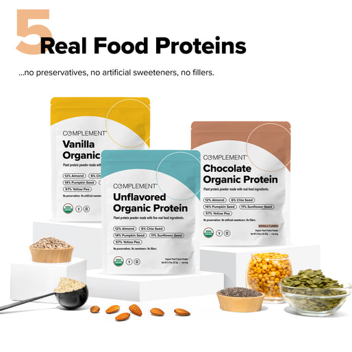 Three colorful bags of Complement organic protein powder (Vanilla, Unflavored, Chocolate) are displayed with measuring scoops and bowls of ingredients like almonds, seeds, and lentils around them. Text highlights real food proteins.