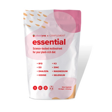 A white and pink package labeled essential by Plant You x Complement. It is a plant-based multivitamin featuring nutrients like B12, D3, K2, Iodine, Zinc, DHA/EPA, Magnesium, and Selenium. Suitable for vegans and gluten-free diets.