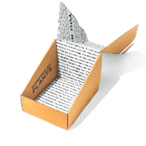 A simple cardboard box is partially open with flaps printed in black text on white paper. The outside of the box reads Powered by Plants in bold black letters. Shadows are cast on a plain white background.