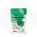 A white and green pouch labeled Daily Greens dietary supplement powder features images of leafy greens and lists spinach, moringa, chlorella, barley grass, and broccoli sprouts as ingredients.