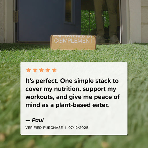 A box labeled “EMPOWERED BY COMPLEMENT” sits on grass outside a door. A 5-star review for the COMPLEMENT® Plant-Based Essentials Stack by Complement, signed by Paul (verified purchase, 07/12/2025), praises its nutrition and workout support.