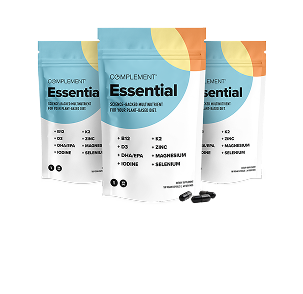 Three pouches of Complement Essential supplements with a blue and orange design are shown, along with several black capsules in front of the pouches, on a light gray background.