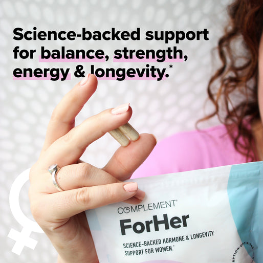 A woman holds two capsules and a packet labeled Complement ForHer with text promoting science-backed support for balance, strength, energy, and longevity. A female gender symbol is in the corner.
