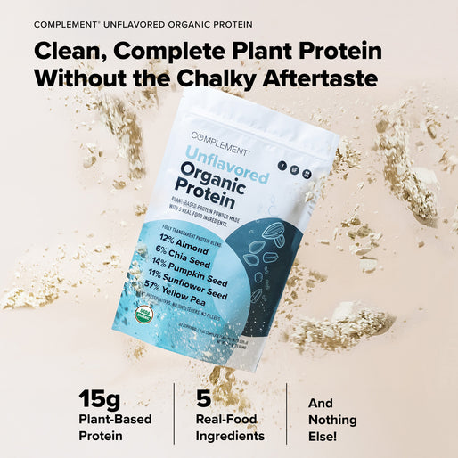 A bag of COMPLEMENT® Plant‑Based Essentials Stack by Complement stands upright with protein powder splashing around it. Text highlights 15g plant-based protein, 5 real-food ingredients, and no added ingredients.