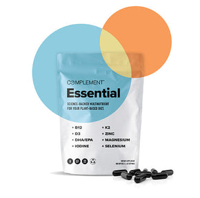 A white pouch labeled Complement Essential with text describing plant-based nutrients like B12, D3, and magnesium. Black capsules are scattered at the base, and two overlapping circles in blue and orange adorn the top-right corner.
