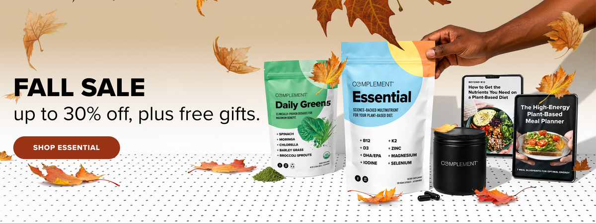 A fall sale banner with plant-based supplement products, autumn leaves, and text saying up to 30% off, plus free gifts. A hand holds a pack labeled Essential. A Shop Essential button is visible.