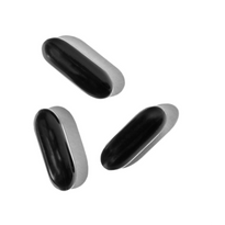 Three black and silver capsule-like objects are scattered on a white background.
