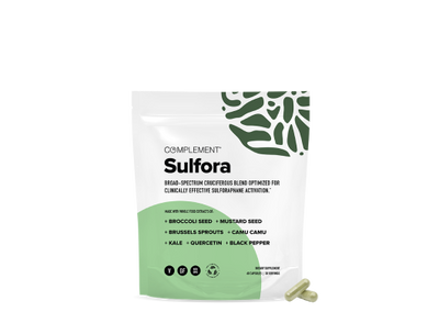 A white and green pouch labeled Complement Sulfora with ingredients listed below, including broccoli seed, mustard seed, brussels sprouts, and kale. Two capsules are placed beside the pouch on a white background.