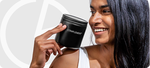 A smiling woman with long dark hair holds a black jar labeled CROWD DENT near her shoulder against a light background with a faint circular design.