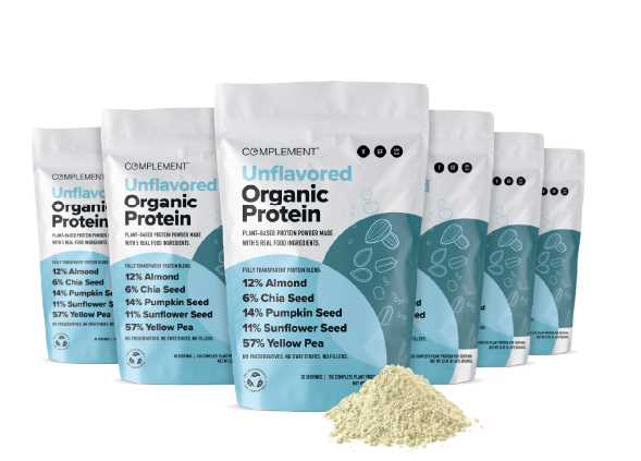 Rows of Complement Unflavored Organic Protein bags with a white and blue design. Ingredients include almond, chia seed, pumpkin seed, sunflower seed, and yellow pea. A small mound of protein powder is in front.